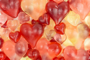 background of gummy candy of hearts in red, pink and white