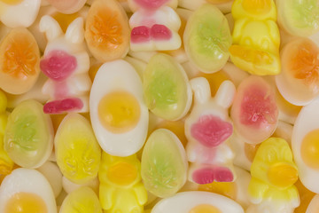 background of gummy candy easter eggs, easter bunny and chicks