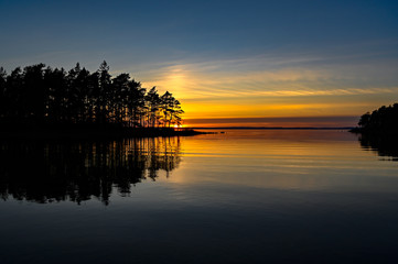 Fototapeta na wymiar orange sunset over a calm lake in Sweden
