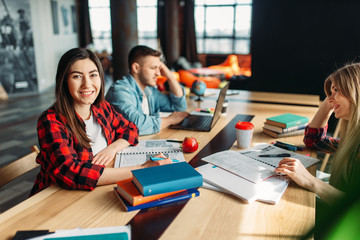 Group of university students sitting at the table