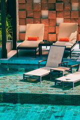 Beautiful outdoor swimming pool in hotel and resort with chair and deck for leisure vacation