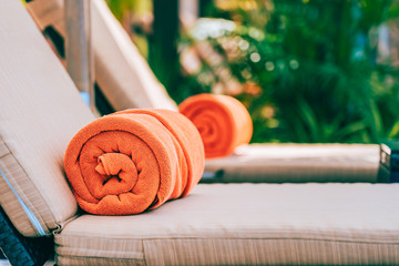 Orange pool towel on deck chair