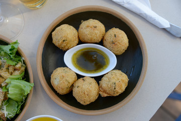 bowl of cookie with a pot of olive oil with herbs in the center