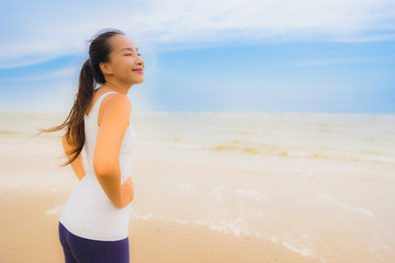 Portrait beautiful young sport asian woman exercise by run and jogging on the outdoor nature beach and sea