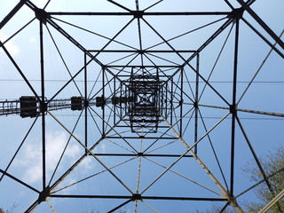 The pylon of the cableway that connects the towns of Albino and Selvino. Green painted pylons to camouflage them in the woods