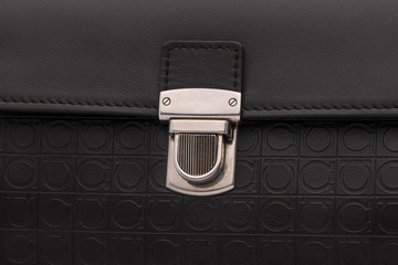 luxury lock clasp on black leather bag, close-up