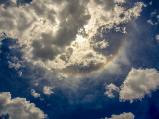 A part of a solar halo shows up trought the midday clouds over the Andean mountains of central Colombia.