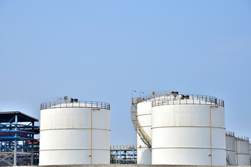 Big white gasoline and oil industry of storage tanks in the blue sky white cloud background