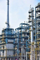 Close-up of pipelines and destillation tanks of an oil-refinery plant