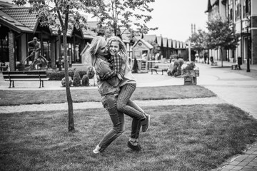 Family relationship concept. Woman during the city with the little adorable girl at street outdoors. Mother and daughter