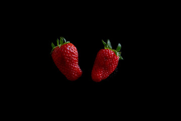 Fresh strawberries on a black background. Horizontal orientation