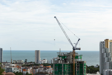 Fototapeta na wymiar Construction high-rise building by construction crane.