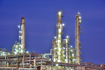 Fototapeta premium Close-up of pipelines and destillation tanks of an oil-refinery plant