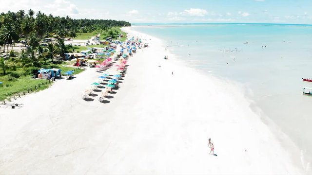 Aerial Forward: Amazing Tropical White Sand Beach by the Bright Blue Ocean in Porto de Galinhas, Brazil