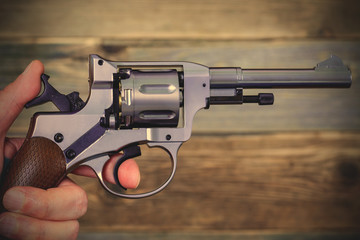 human hand with revolver