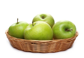 Green apple in wooden wicker basket isolated on white background