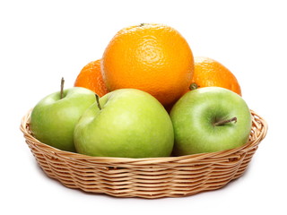 Ripe orange and  green apple in wooden wicker basket isolated on white background