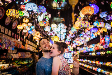 Fototapeta premium Couple embracing each other under turkish lights