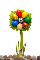 Seven-color flower of Easter eggs with a soccer ball and a ladybug on an isolated background