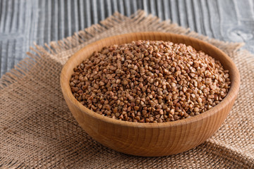 Grain buckwheat on a gray wooden background