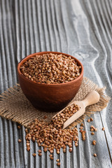 Grain buckwheat on a gray wooden background