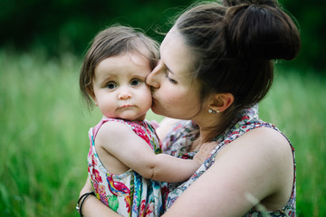 Mum kissing child