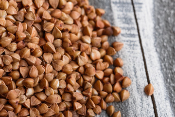 Grain buckwheat on a gray wooden background