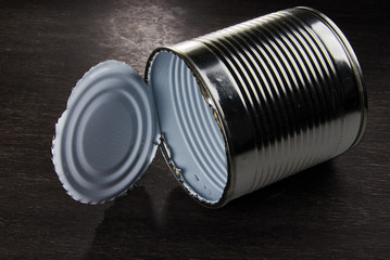 Tin can on a wooden table.