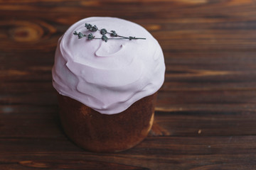 Happy Easter background with an easter bread cake decorated with glaze, chocolate and  eggs. For greeting card, ad, promotion, poster, flyer. complex composition, beautiful scenery, movement, hands