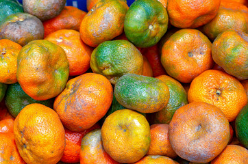 A heap of mandarin oranges. Captured at the traditional local market of the colonial town of Villa de Leyva, in central Colombia.