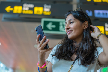 young indian woman typing a message
