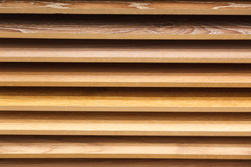 Obraz premium Sample parquet boards in hardware store, in home improvement warehouse exterior. Picture of different colors wooden laminate flooring shop. Concept housewarming, repair, renovation