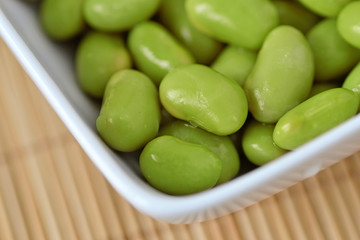 Closeup of edamame soy beans in a white bowl