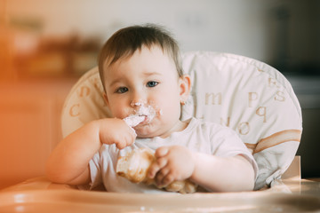 baby in the kitchen eagerly eating the delicious cream horns, filled with a vanilla cream