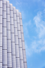 High-rise buildings in the blue sky white cloud background