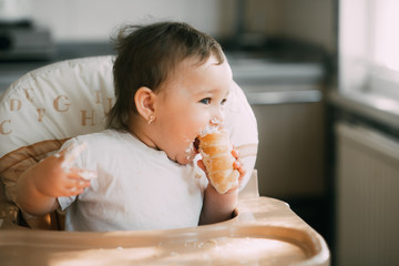 baby in the kitchen eagerly eating the delicious cream horns, filled with a vanilla cream