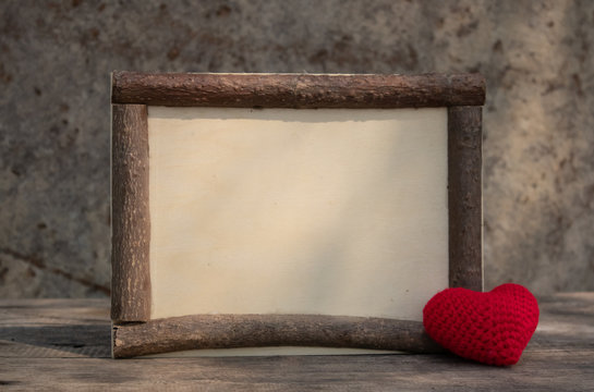 wooden frame with heart on the wooden table