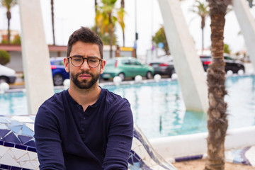Fototapeta premium young man sitting in the city