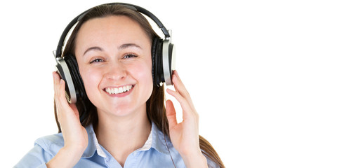 Happy young woman listening to music in headphones on white background