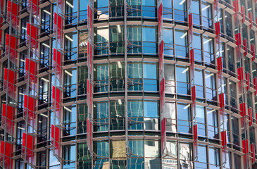 Closeup of blue windows and red walls of a business building