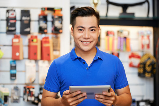 Salesman With Tablet Pc In The Shop