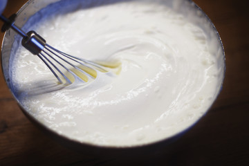 cream is whipped with a mixer in a bowl