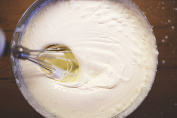 cream is whipped with a mixer in a bowl