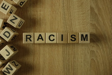 Racism word from wooden blocks on desk