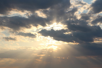 sun behind the clouds