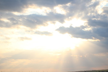 Obraz premium sun behind the clouds