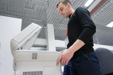 A office man operating a copy machine