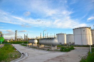 Refinery storage tanks and containers of ethanol under the blue sky white clouds