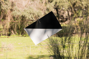 A sign upside down of a Hunting preserve on a farm fence near Grimaldo