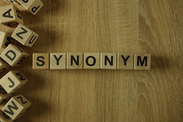 Synonym word from wooden blocks on desk